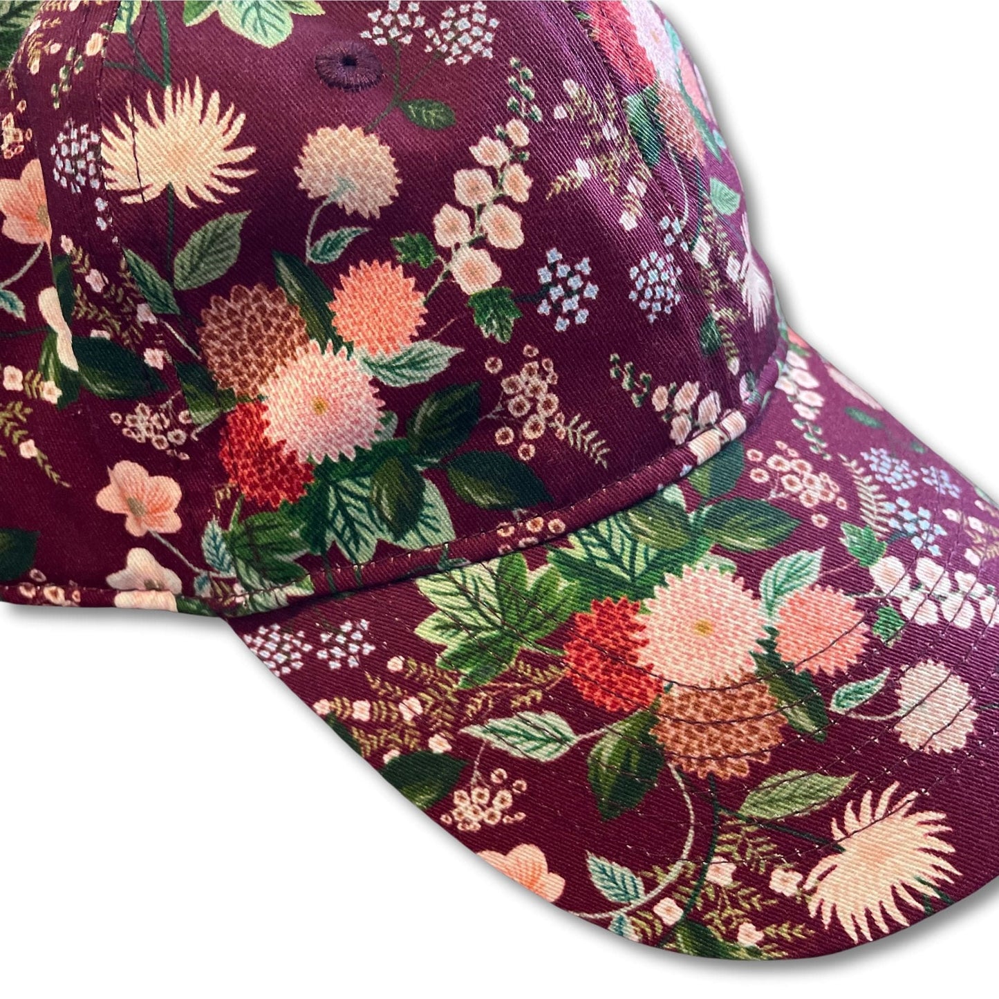 Vibrant women's floral baseball cap with dahlia flower pattern.