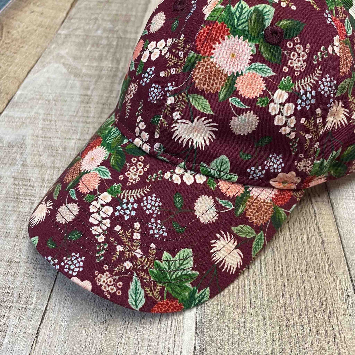Pretty and vibrant, women's floral baseball cap with dahlia flower pattern.