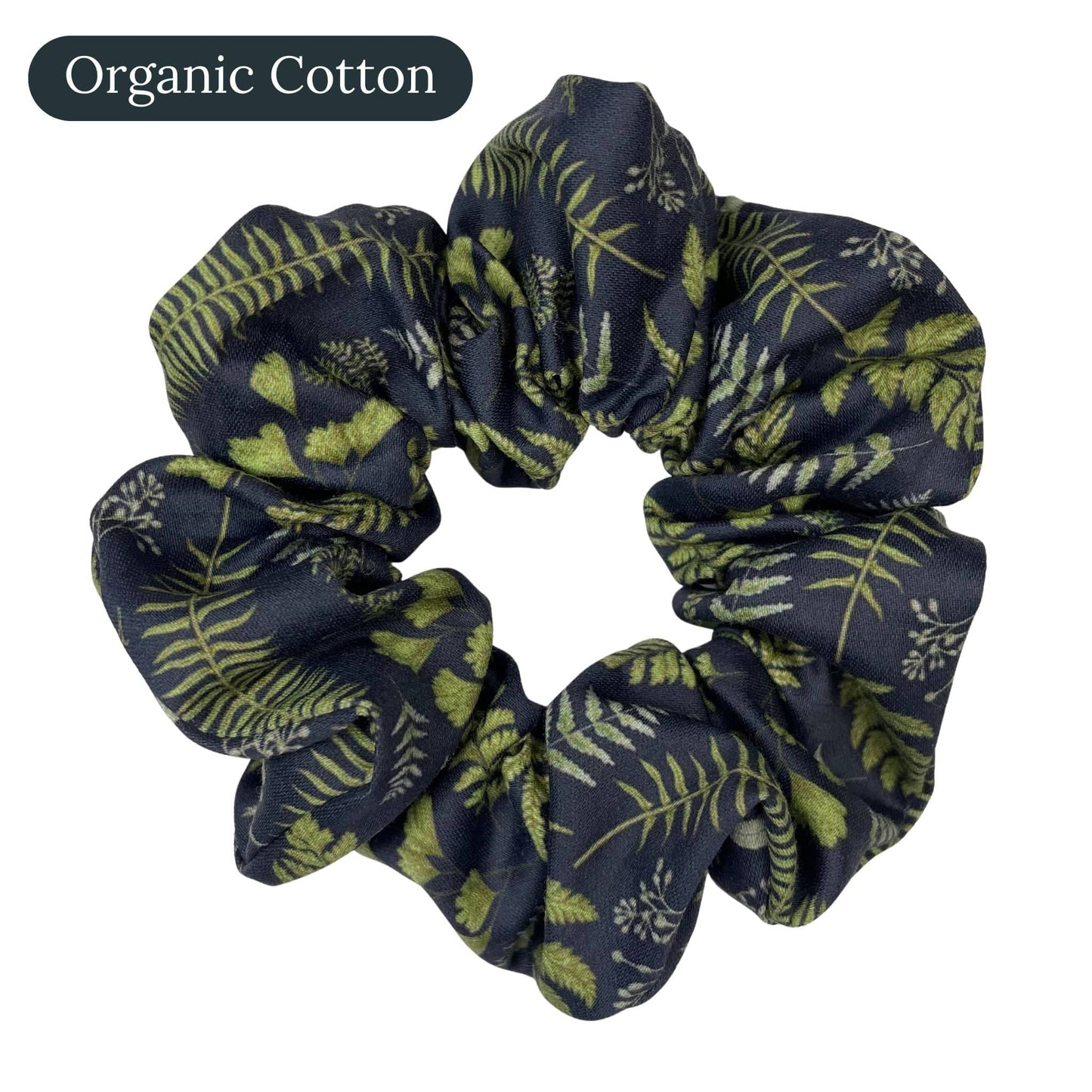 Navy blue organic cotton scrunchie with green leaf and fern pattern on a white background