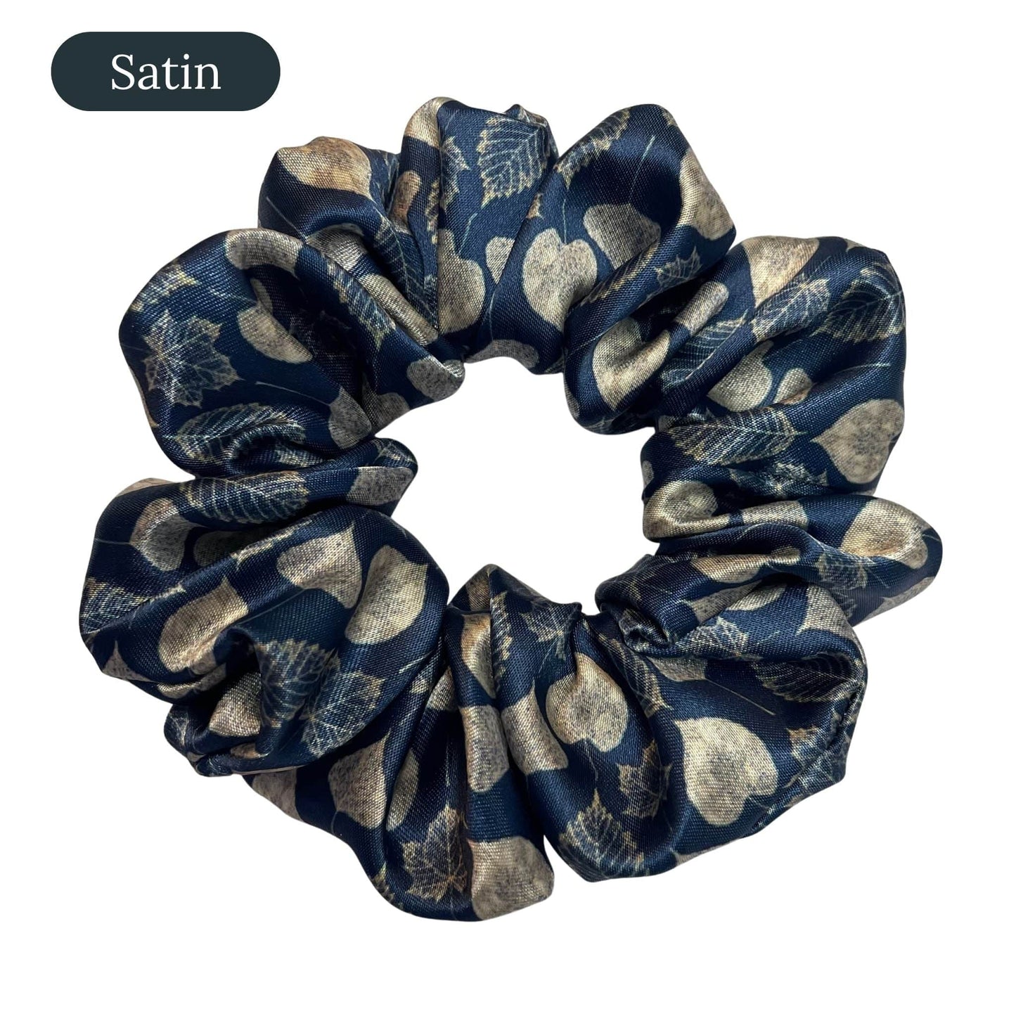 Navy blue satin scrunchie with leaf pattern on a white background