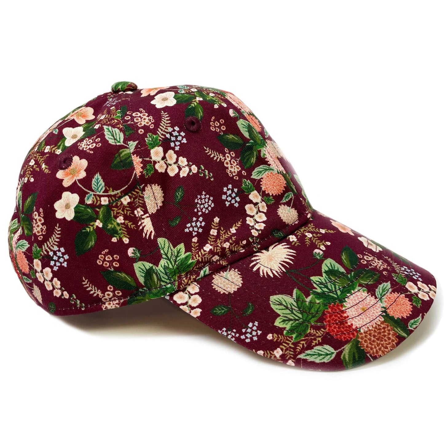 A fun, vibrant women's floral baseball cap with dahlia flower pattern.