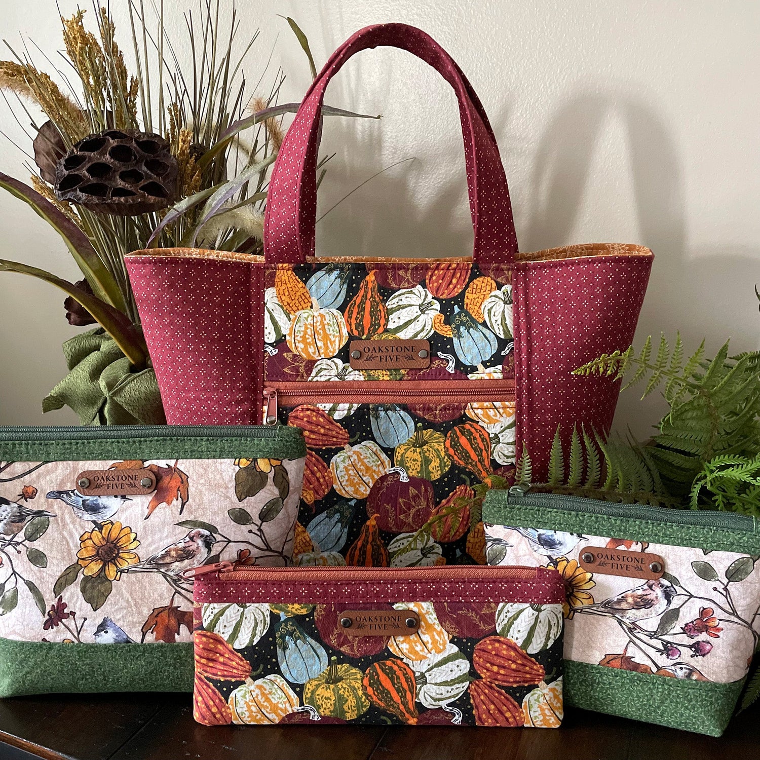 Beautiful, nature-inspired, handmade women's tote bag and zipper pouches, sitting on a table with plants.