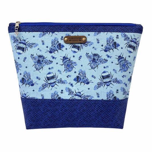 Blue floral bumble bee patterned zipper pouch with a white background