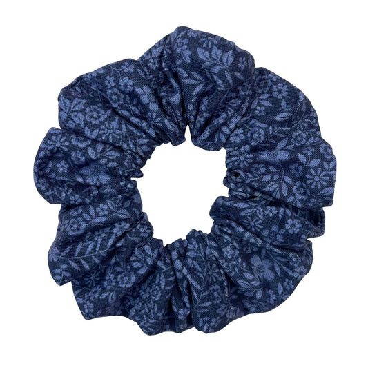 Blue floral patterned scrunchie on a white background
