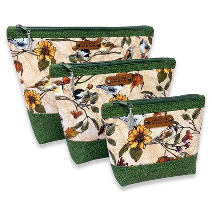Three zipper pouches with nature-themed design featuring birds and flowers on a white background