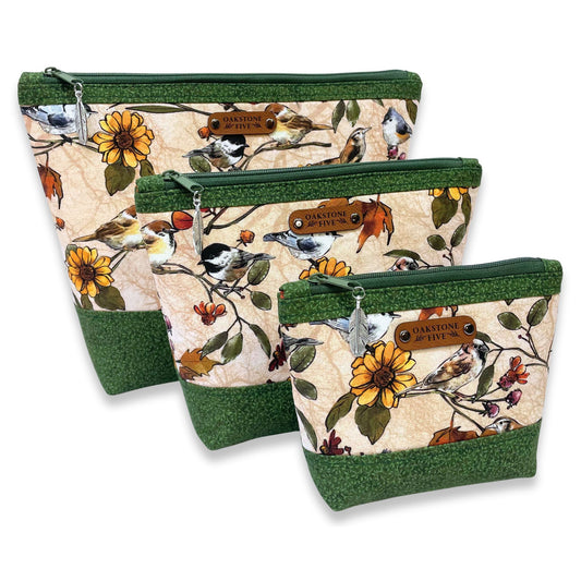 Three zipper pouches with nature-themed design featuring birds and flowers on a white background