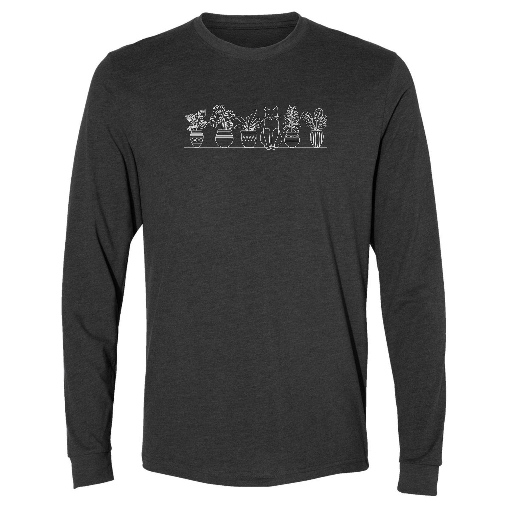 A dark gray, cute, long-sleeve plant t-shirt for gardeners that has a row of potted plants sitting on shelf, with a cat sitting in the middle.
