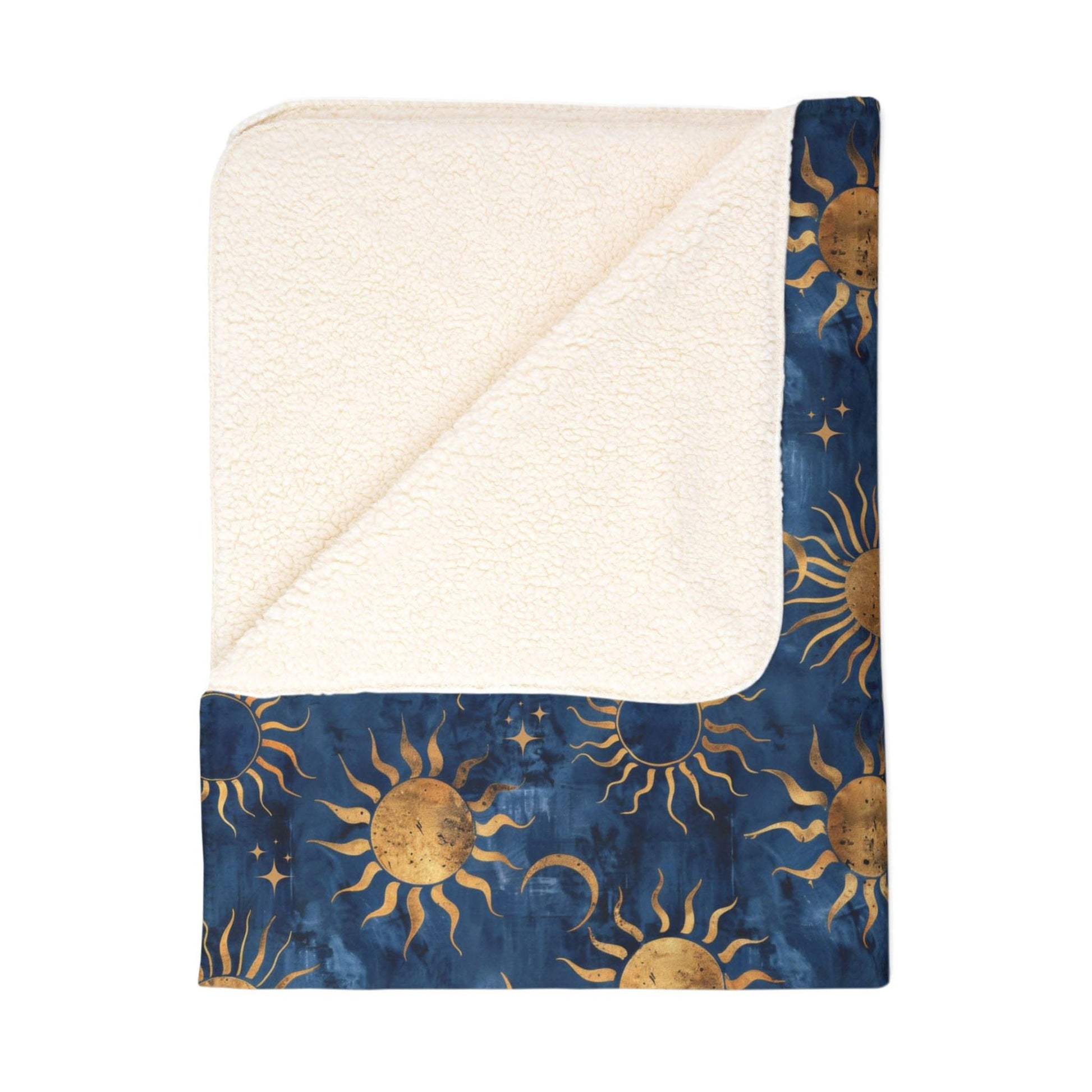 Folded sherpa blanket featuring a vibrant blue background with a celestial motif of sun, moon, and stars.