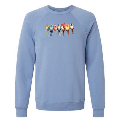 A lavender blue, women's bird sweatshirt that has a row of colorful birds sitting on a tree branch.