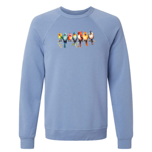 A cute, women's sweatshirt for birders that has a row of colorful birds sitting on a tree branch.