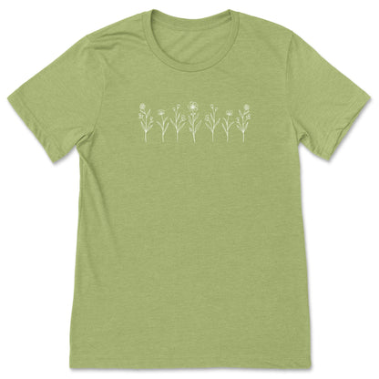 A bright green, cute white wildflower t-shirt for nature lovers and flower lovers, that has row of small white flowers across the chest.
