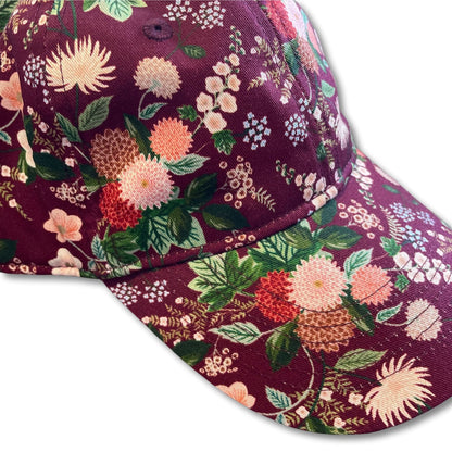 Vibrant women's floral baseball cap with dahlia flower pattern.