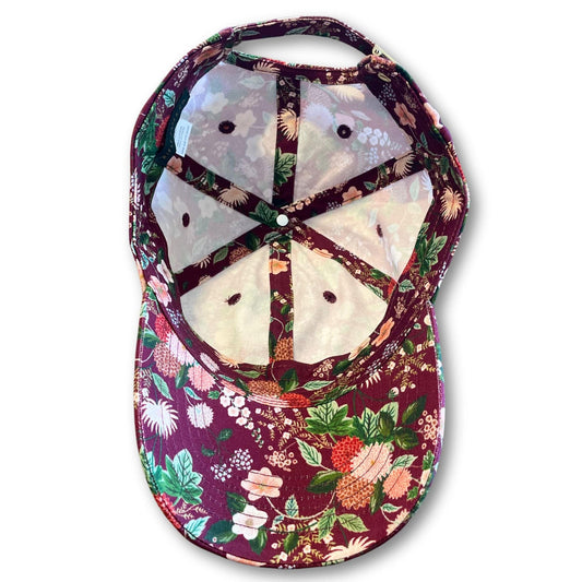 Interior view of a pretty, women's floral baseball cap with a dahlia flower pattern.