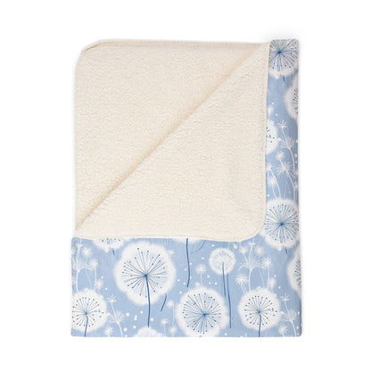 Sherpa blanket with white dandelion pattern on a blue background
