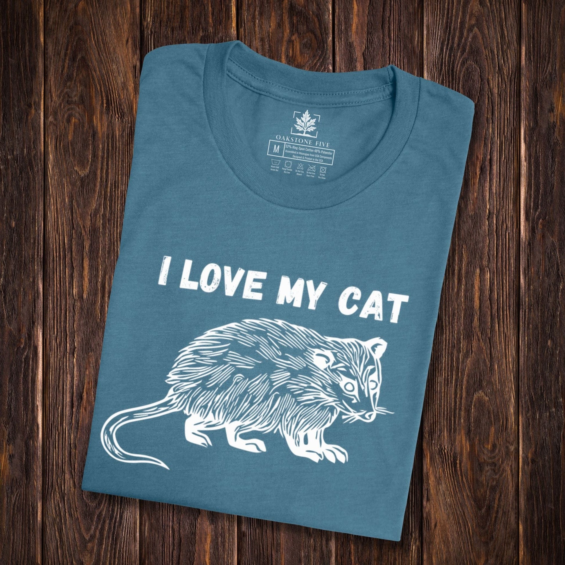 A teal, funny possum shirt for animal lovers that says, "I love my cat".
