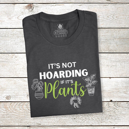 A folded grey funny plant t-shirt for gardeners that has potted plants and says, "It's not hoarding if it's plants".  A great gift idea for plant lovers!