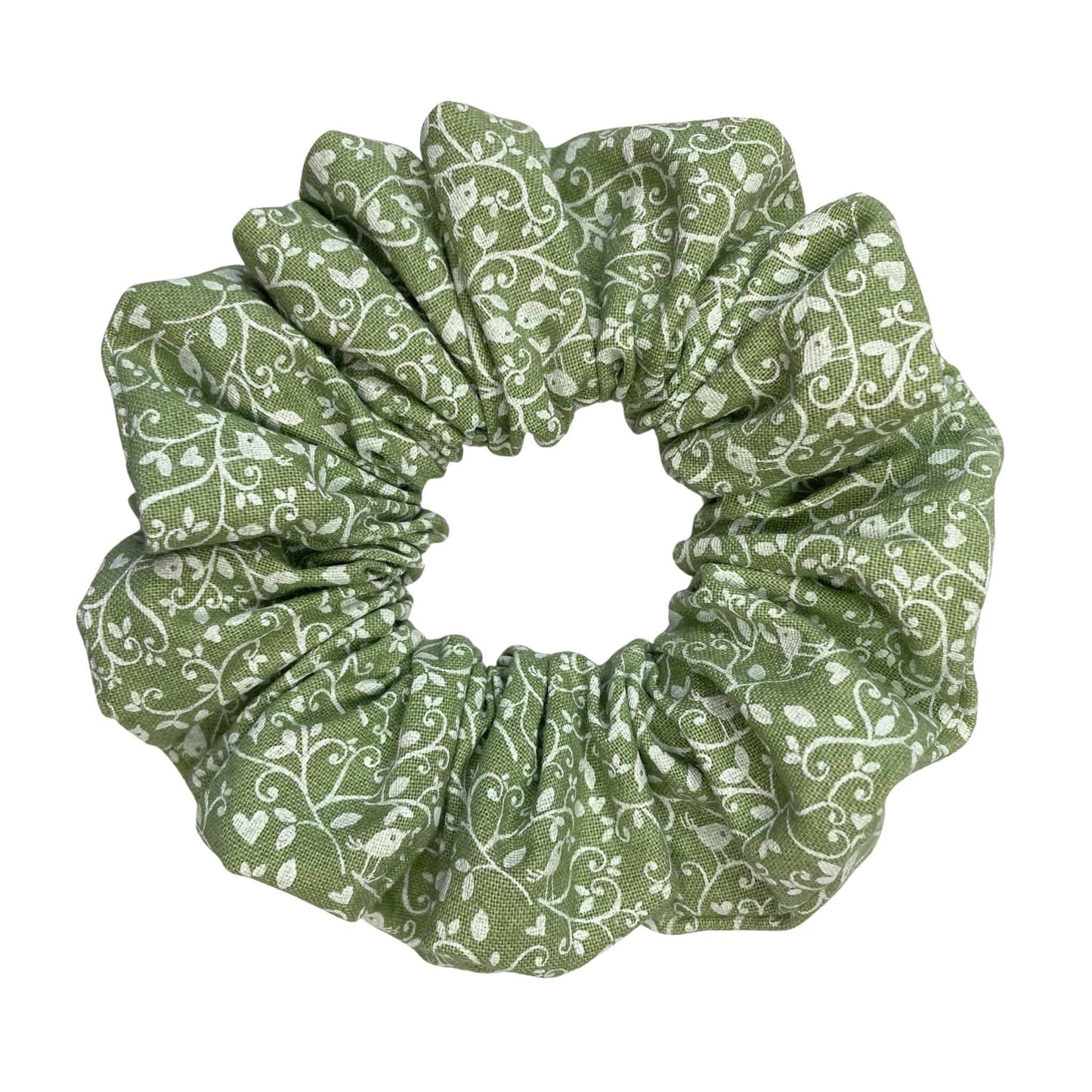 Green scrunchie with white floral and bird pattern on a white background