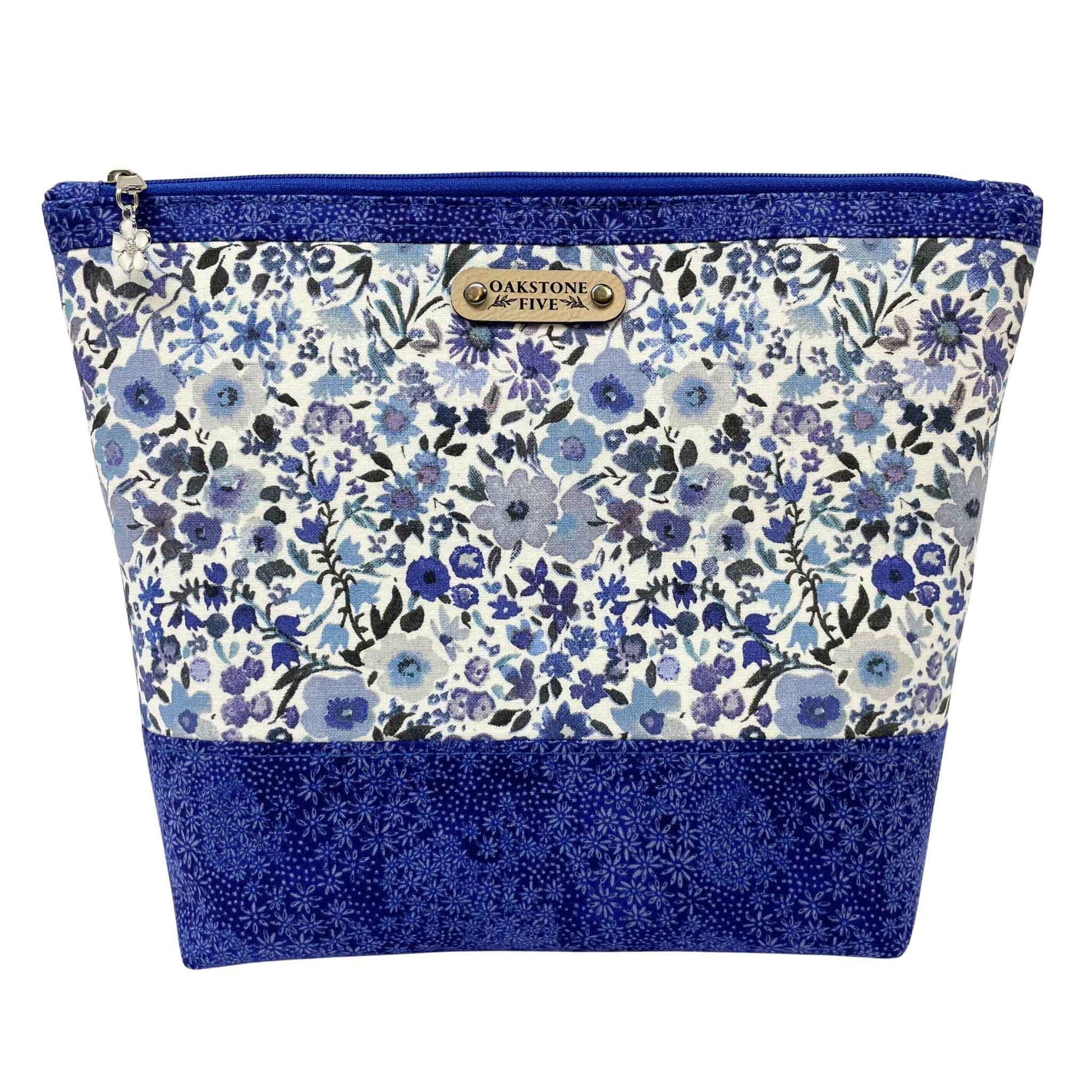 Blue floral-patterned zipper pouch with blue accents on a white background