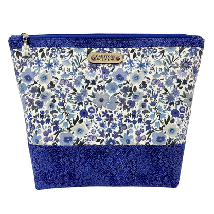 Blue floral-patterned zipper pouch with blue accents on a white background