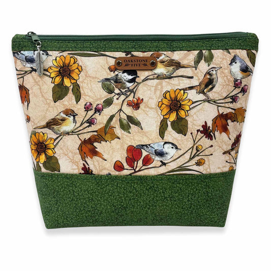 Handmade, nature-themed zipper pouch with bird and floral pattern on a white background