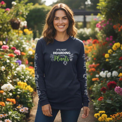 Woman standing outdoors at a greenhouse wearing a navy blue long sleeve shirt with plant-themed design.
