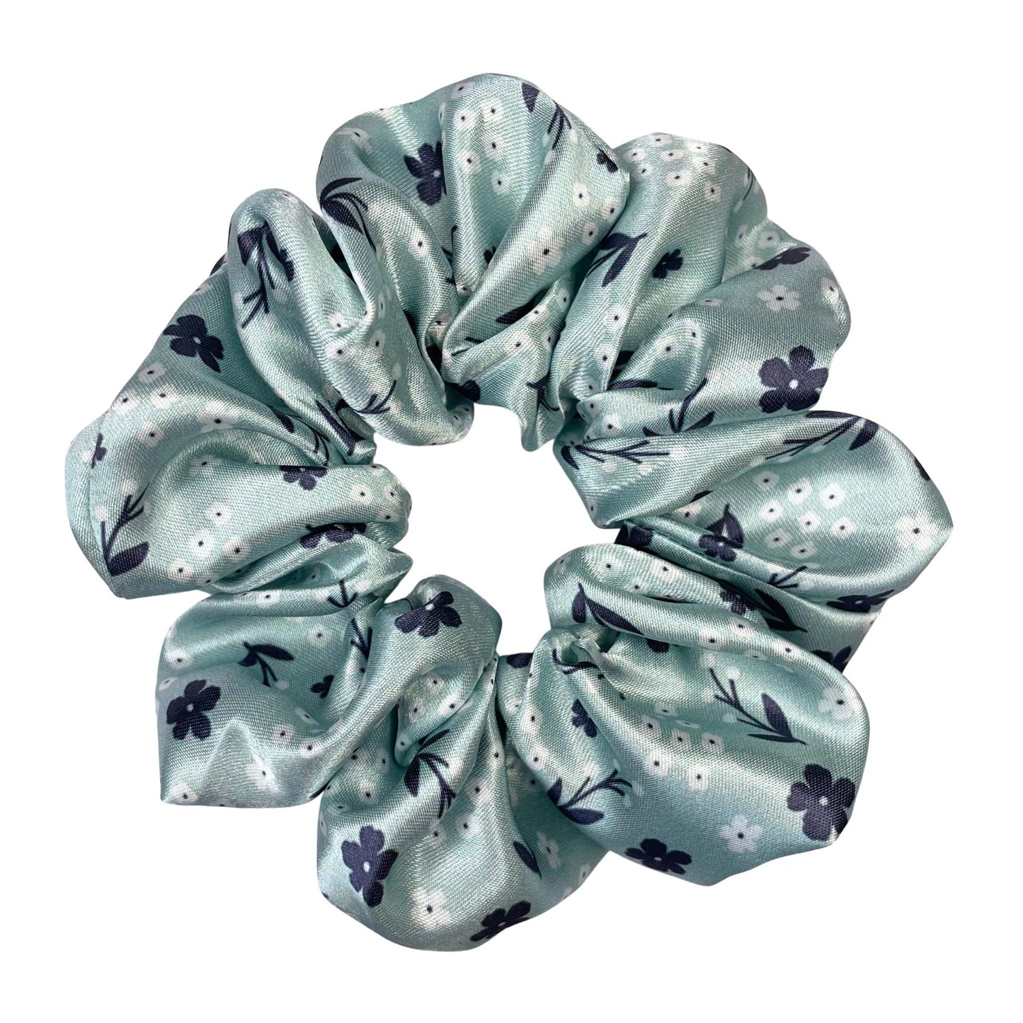 A pretty, light green floral satin scrunchie with navy and white flowers.