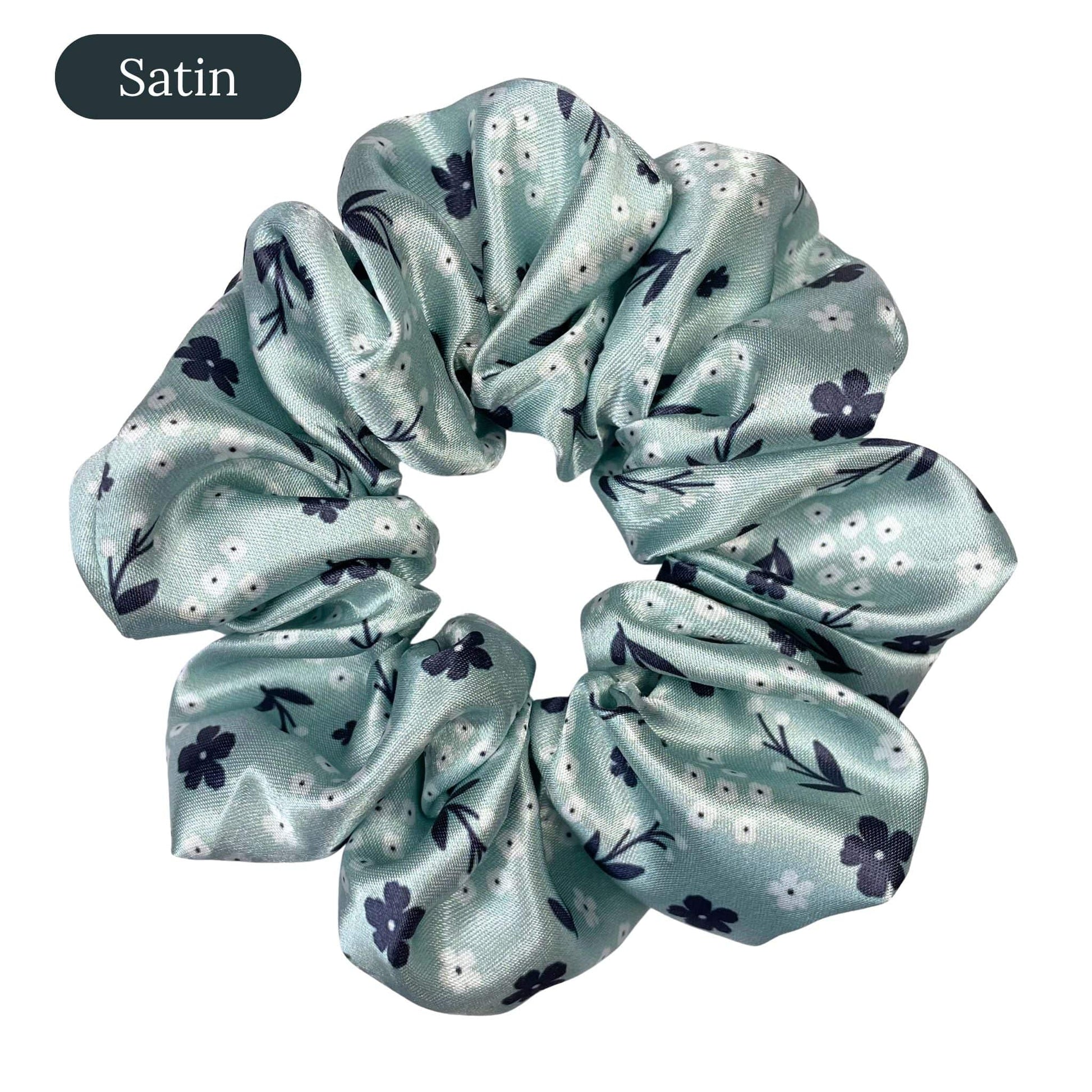 Light green satin scrunchie with floral pattern on a white background