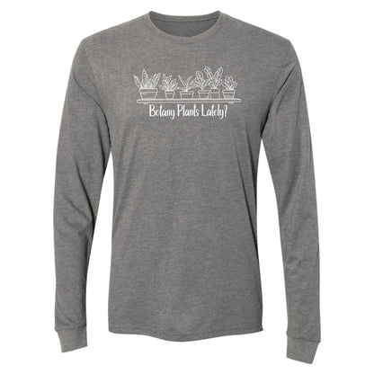 A light gray, long-sleeve, funny botany shirt for plant lovers that has a design with a row of potted plants on a shelf and says, "Botany Plants Lately?"
