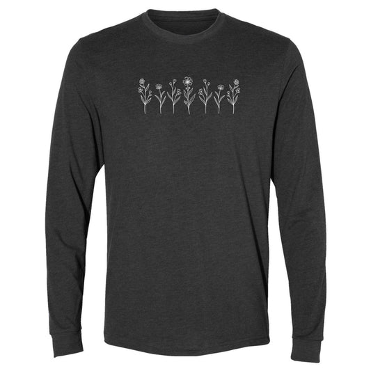 A cute, charcoal gray long-sleeve wildflower t-shirt for nature and plant lovers that has a design on across the chest of several small white wildflowers in a  row.