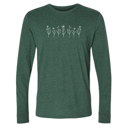 A cute, green, long-sleeve wildflower t-shirt for nature and plant lovers that has a design on across the chest of several small white wildflowers in a  row.
