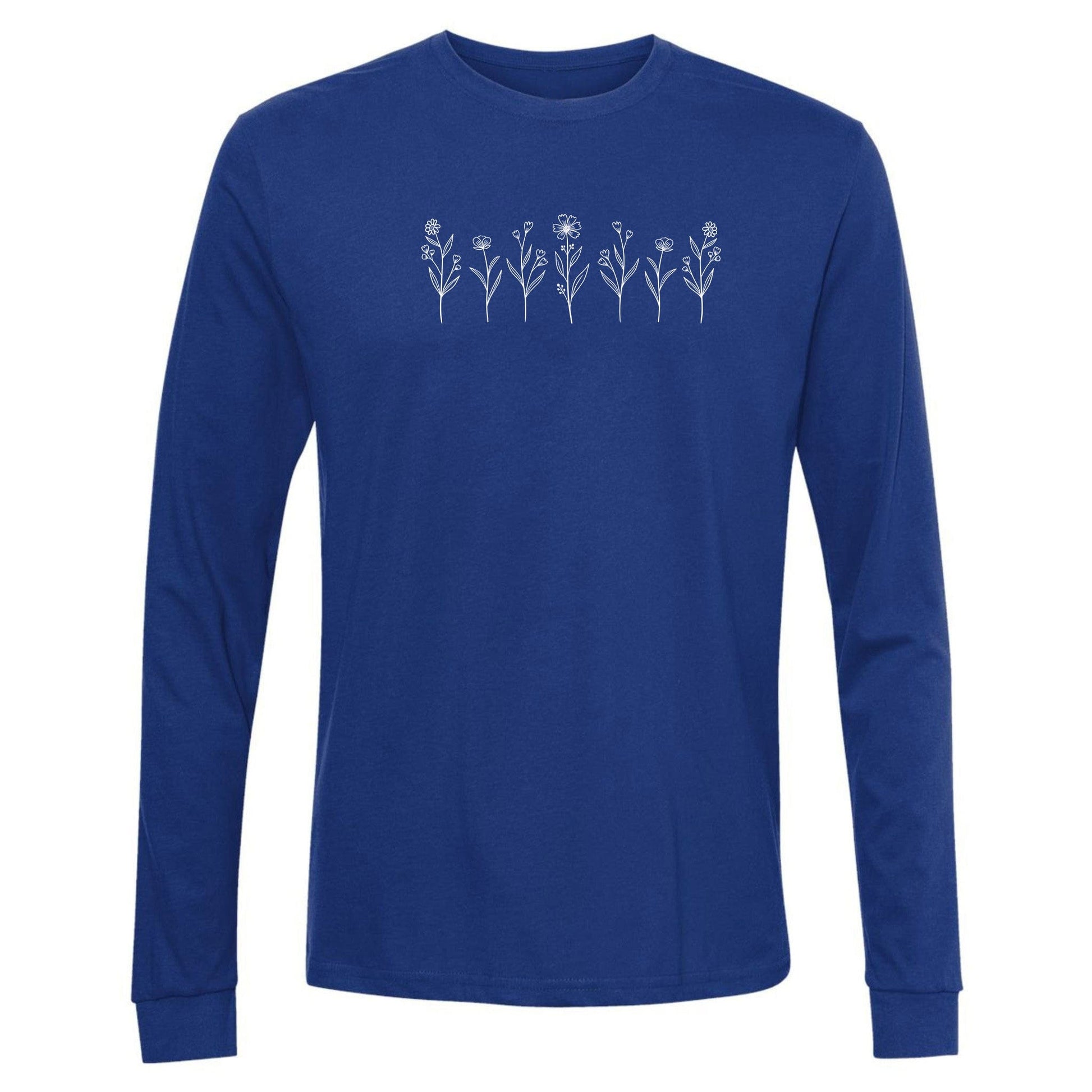 A cute, royal blue, long-sleeve wildflower t-shirt for nature and plant lovers that has a design on across the chest of several small white wildflowers in a  row.
