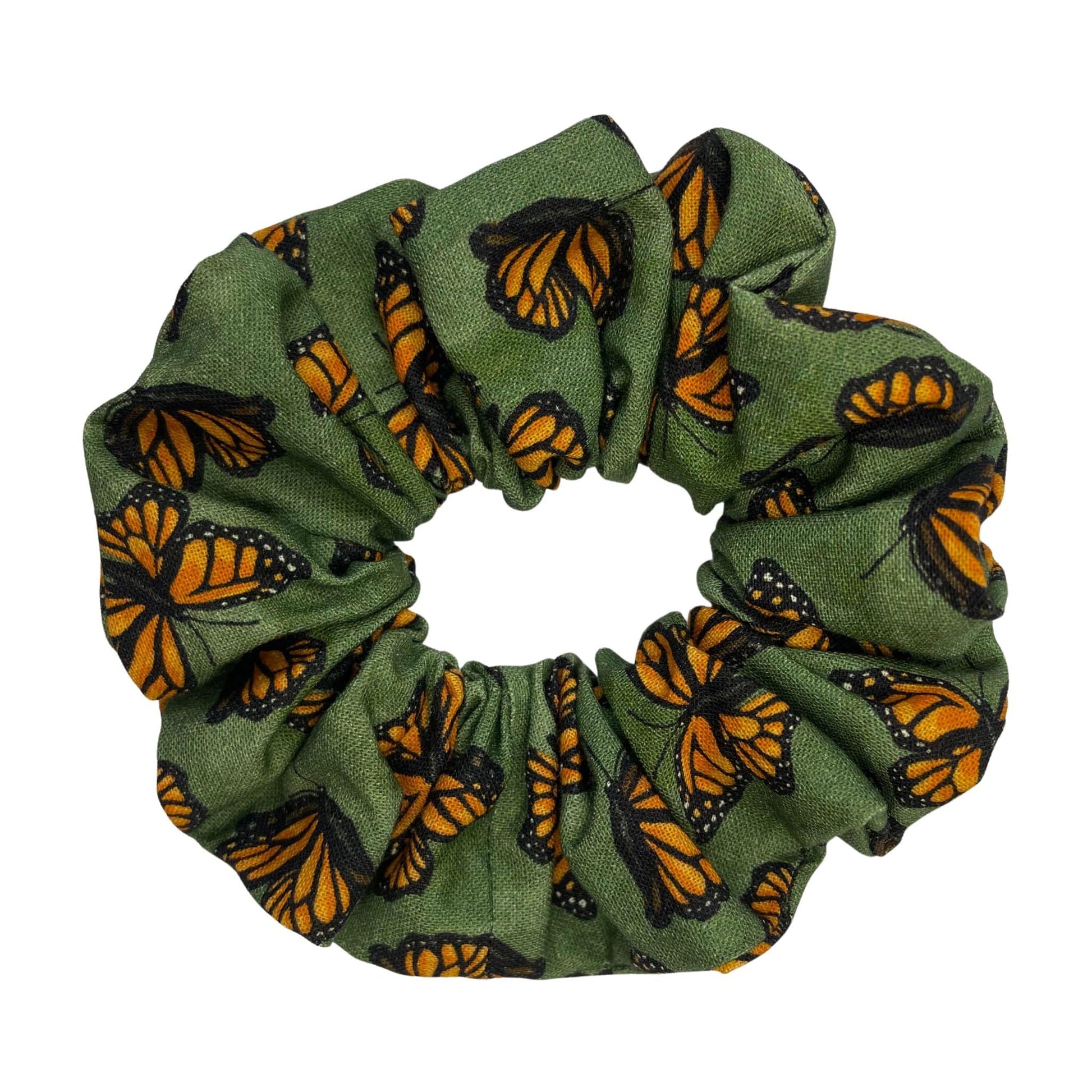 Green hair scrunchie with orange and black monarch butterfly pattern on a white background.