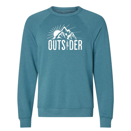 A teal, ultra-soft raglan sweatshirt for nature lovers and outdoor enthusiasts that has a sun behind a mountain and says, "Outsider". 