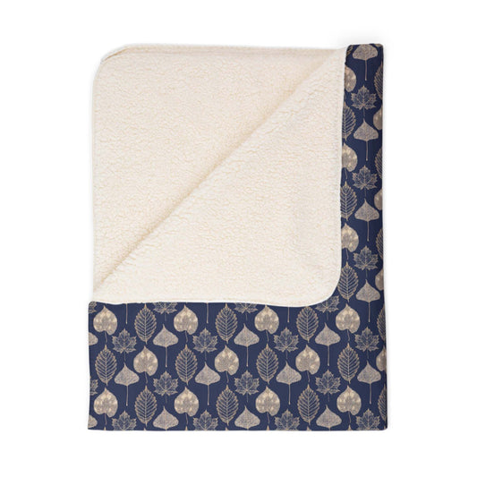 Navy blue, leaf-patterned sherpa throw blanket