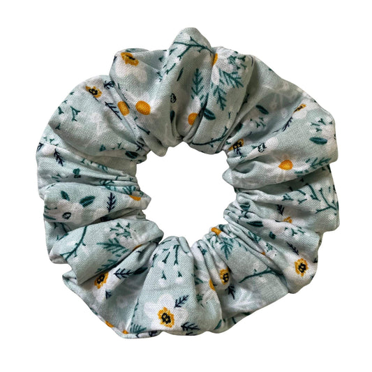 Green floral patterned scrunchie on a white background