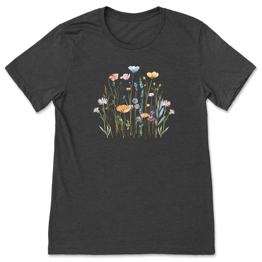 A pretty, dark gray, soft, wildflower shirt for women and gardeners that has a print with pastel flowers on it. 
