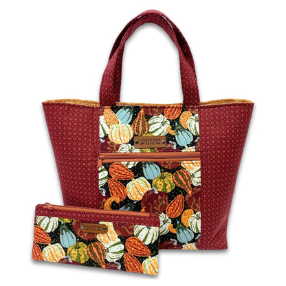 Handmade seasonal tote bag with pumpkin and gourd fall pattern and matching zipper pouch on a white background