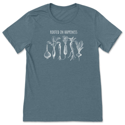 A slate blue positivity shirt for gardeners and plant lovers that has vegetables on it and says, "Rooted in Happiness". 