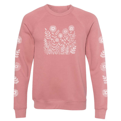 Pink sweatshirt with white floral patterns on the front and on both sleeves, on a white background