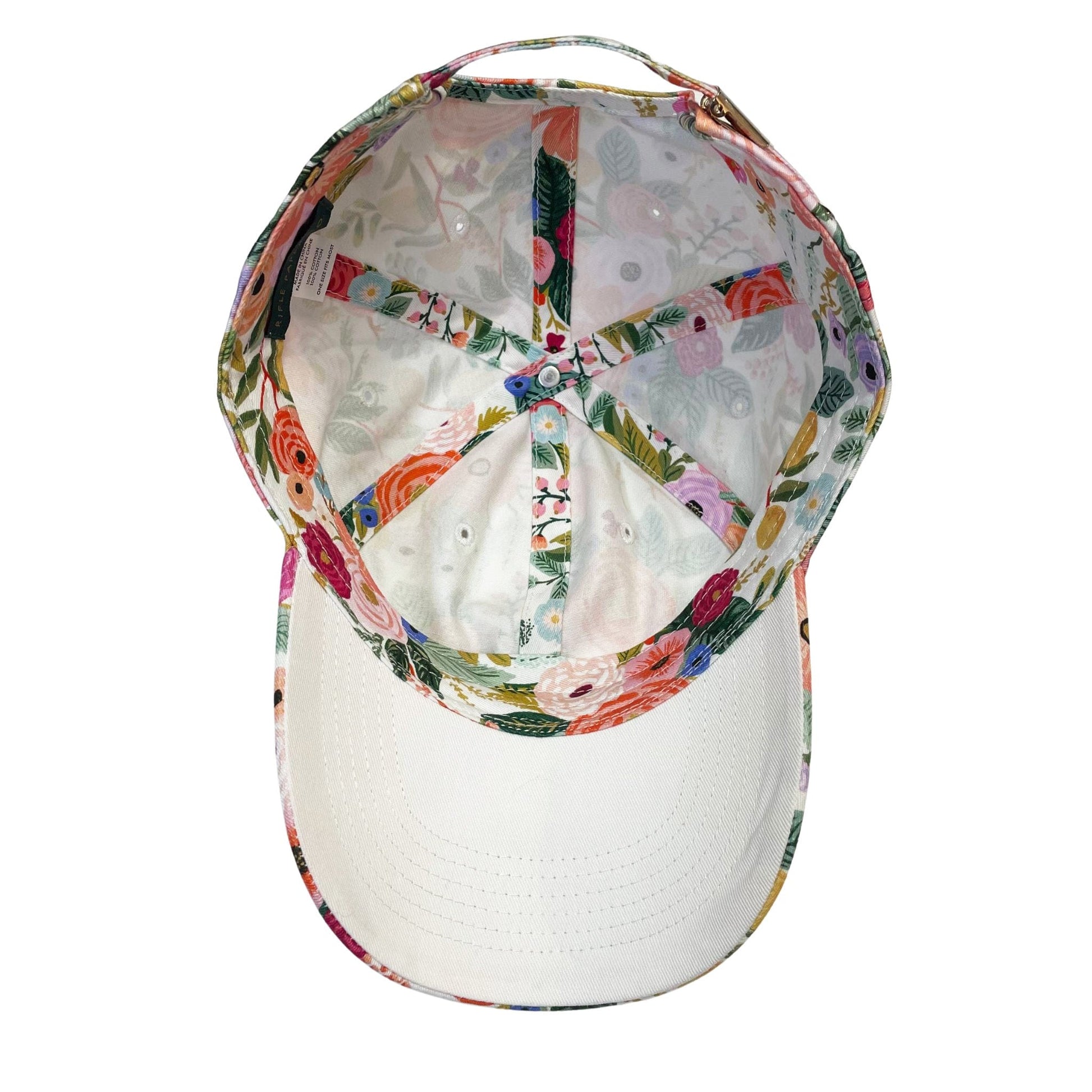 The inside of a women's floral baseball hat that has a colorful flower pattern inside and out!